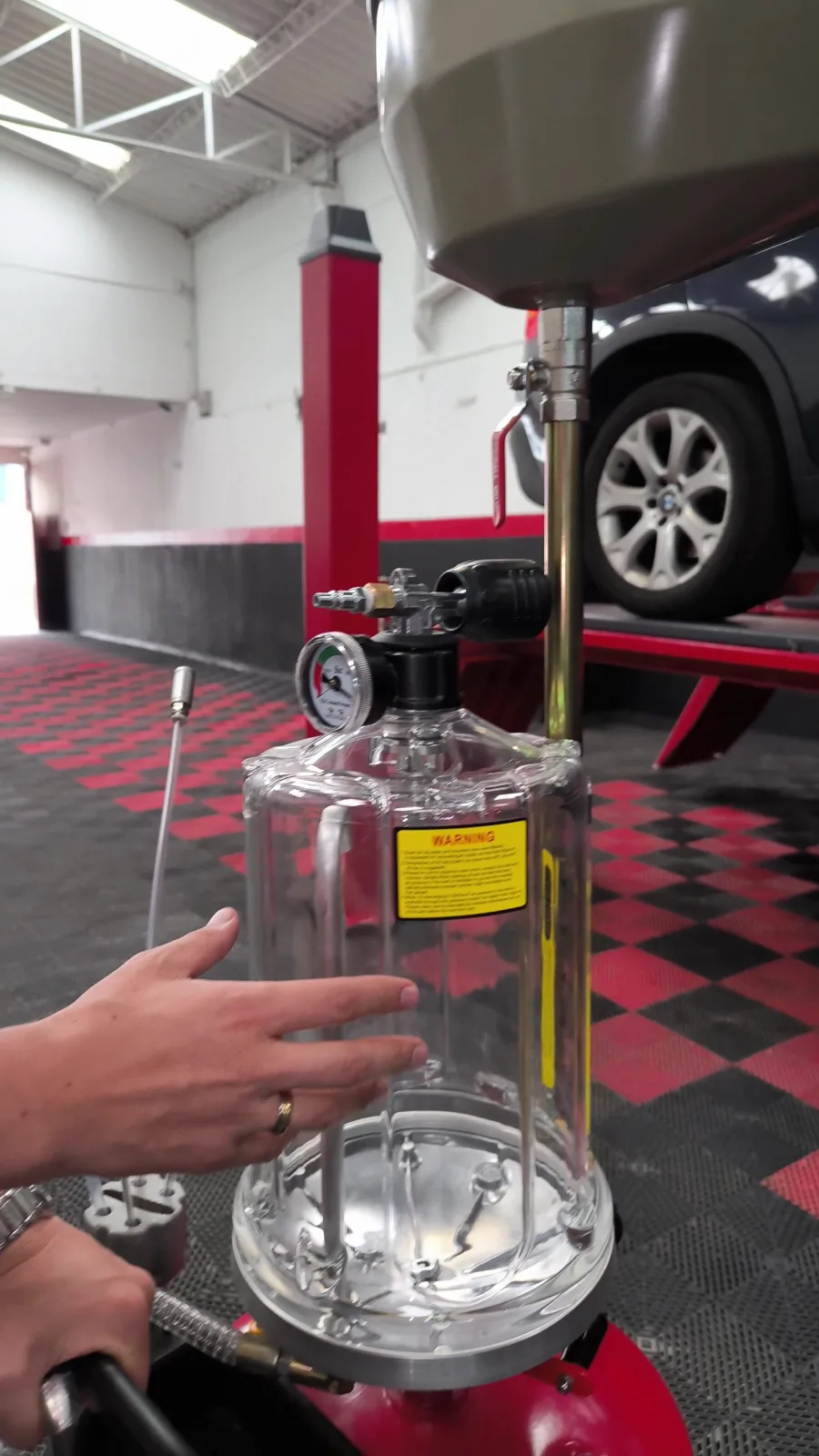 Técnico realizando cambio de aceite con extractor